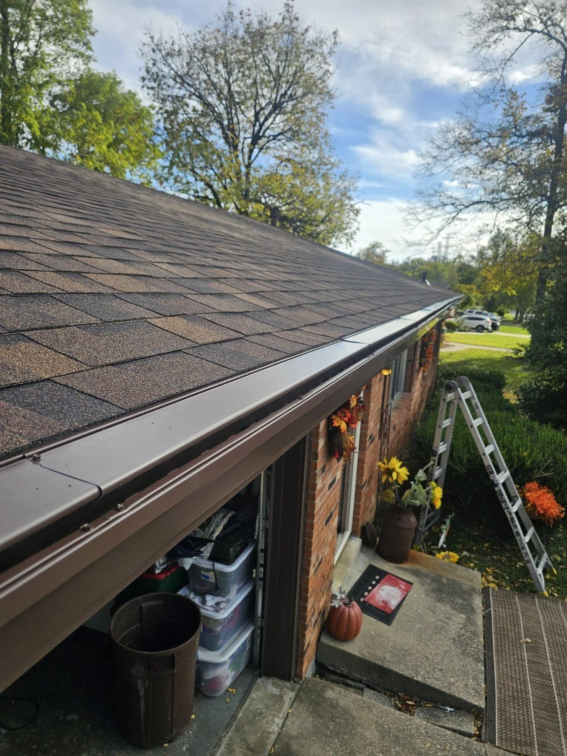Brown seamless gutter with gutter protection on a home