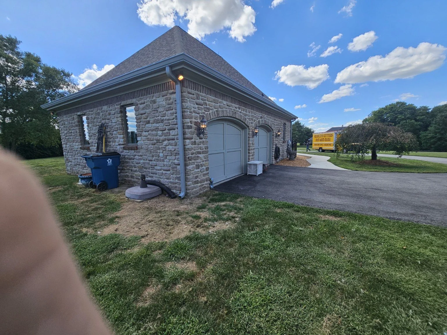 Finished gutter project by Miller Construction on a stone garage in the Indianapolis area