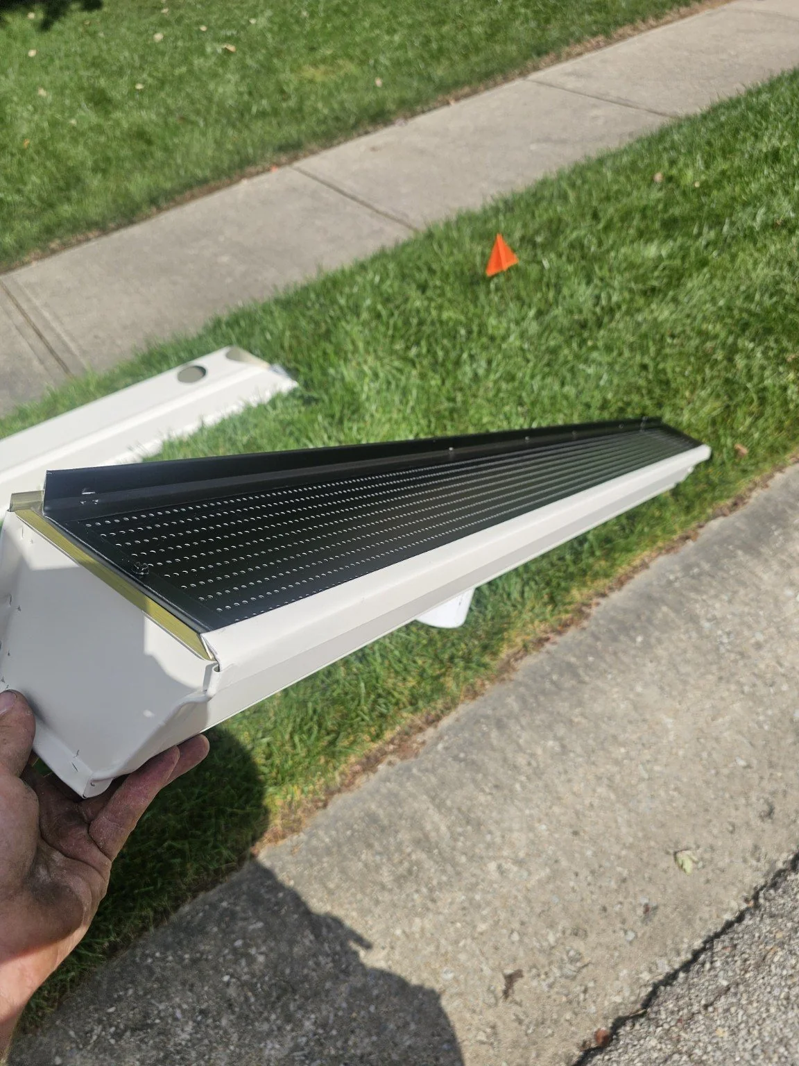 Gutter guard insert held during installation