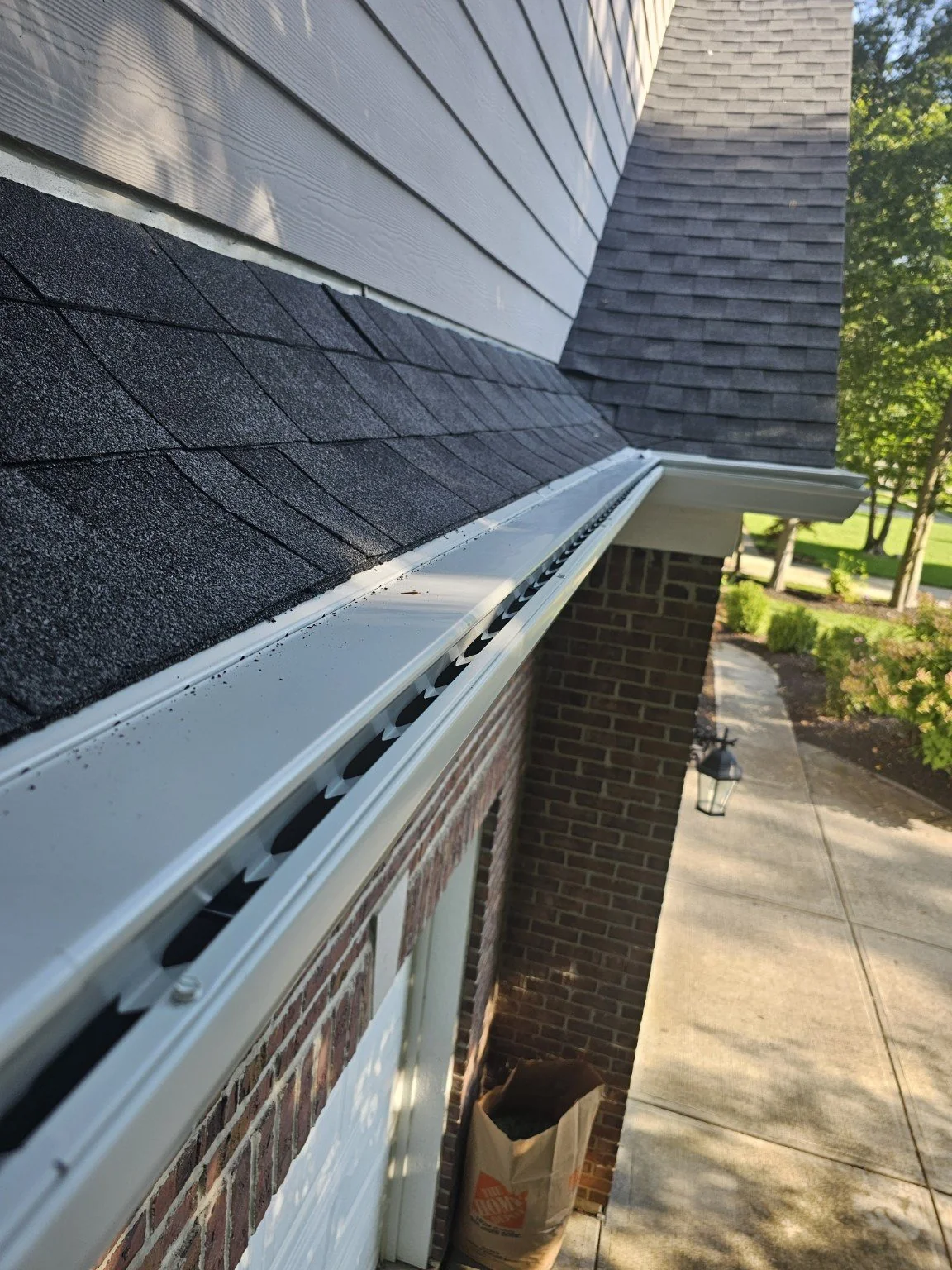 Gutter guard installed inside a white seamless gutter by Miller Construction