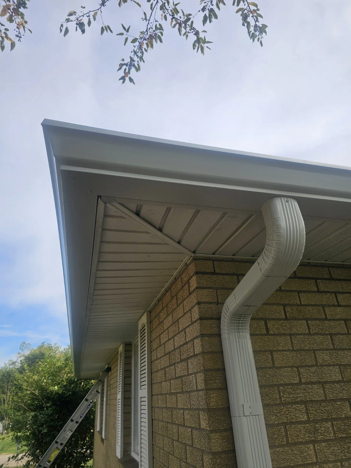 White gutter and downspout detail on a brick Indianapolis home